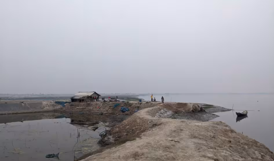 People walk along an embankment in Bangladesh