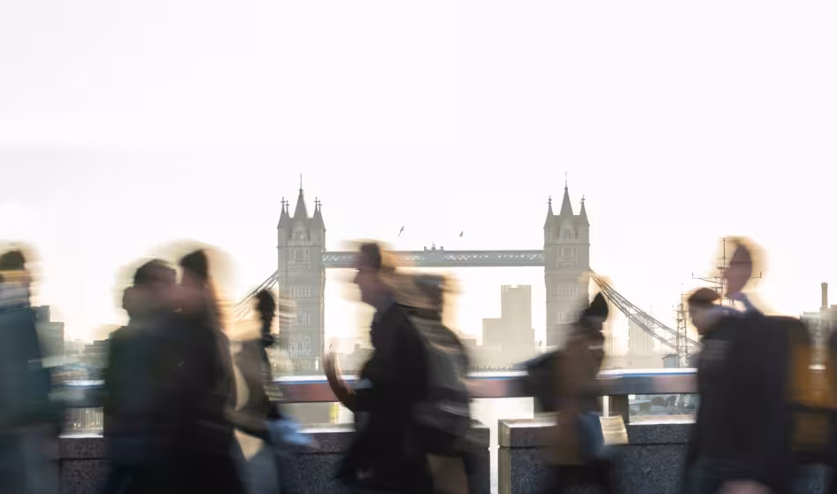 People walk in front of Tower Bridge in London.