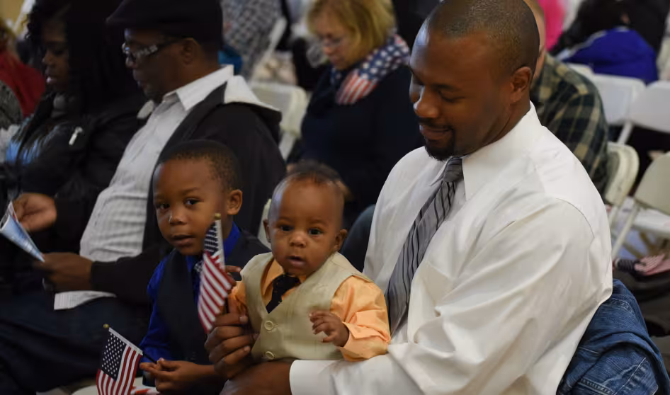 A man and child at a naturalization ceremony outside Washington, DC.