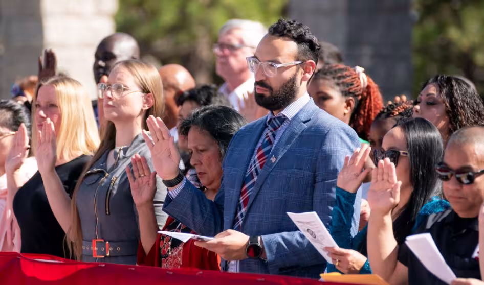 Immigrants take the oath of allegiance during a naturalization ceremony.