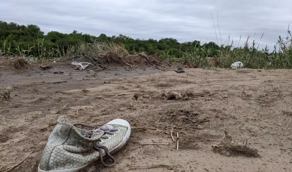 An abandoned shoe lies in the mud along the U.S.-Mexico border.