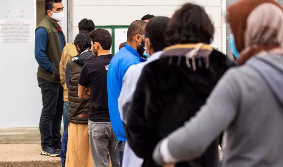 Afghan parolees wait in line at Fort McCoy, Wisconsin.