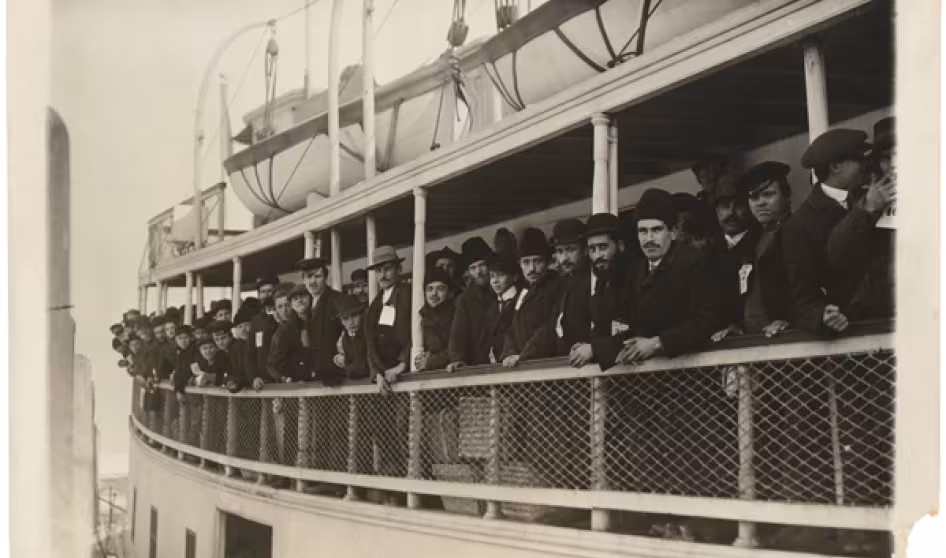 Immigrants arriving on a ferry near Ellis Island.