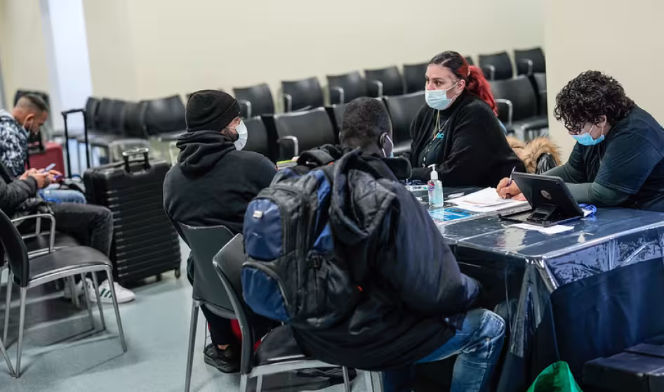 Asylum seekers receive assistance at the Brooklyn Cruise Terminal in New York City.