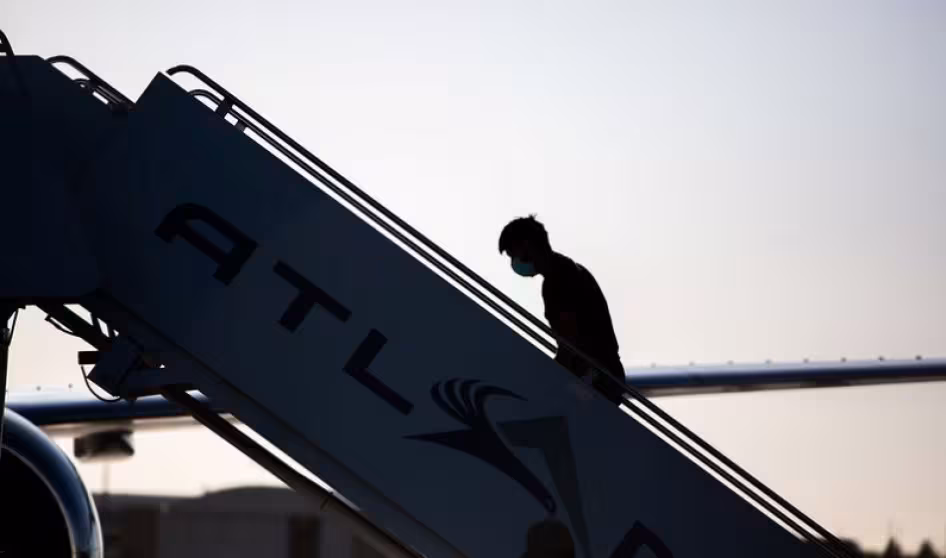 A man boards a repatriation charter flight to Guatemala.