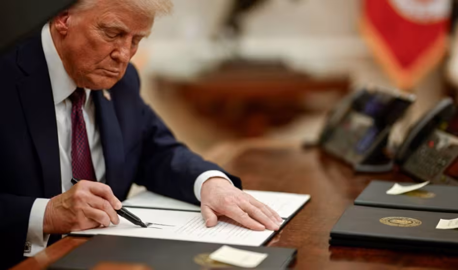 President Donald Trump signs an executive action