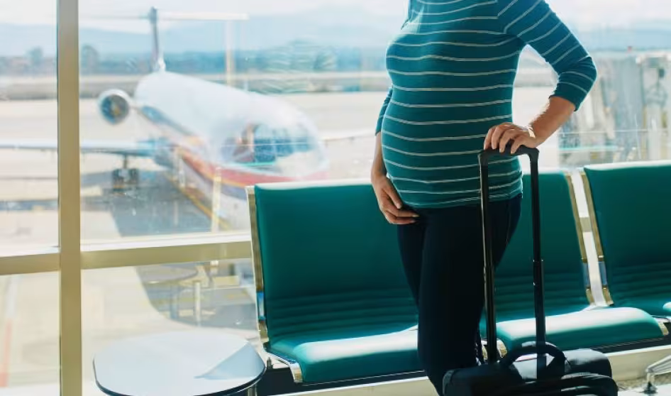 A pregnant woman at an airport.
