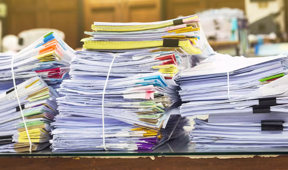 A pile of documents on a desk.