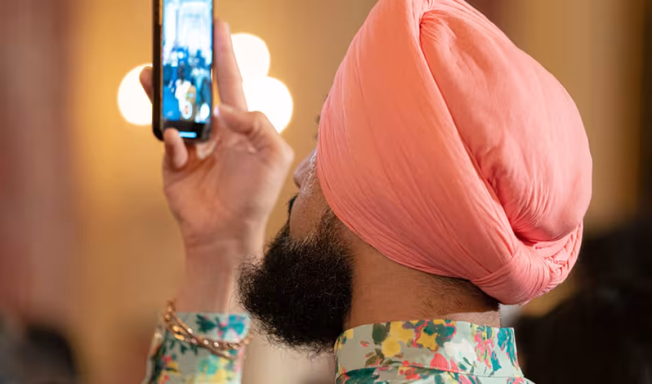 A guest takes a photo at a Diwali reception at the White House. 