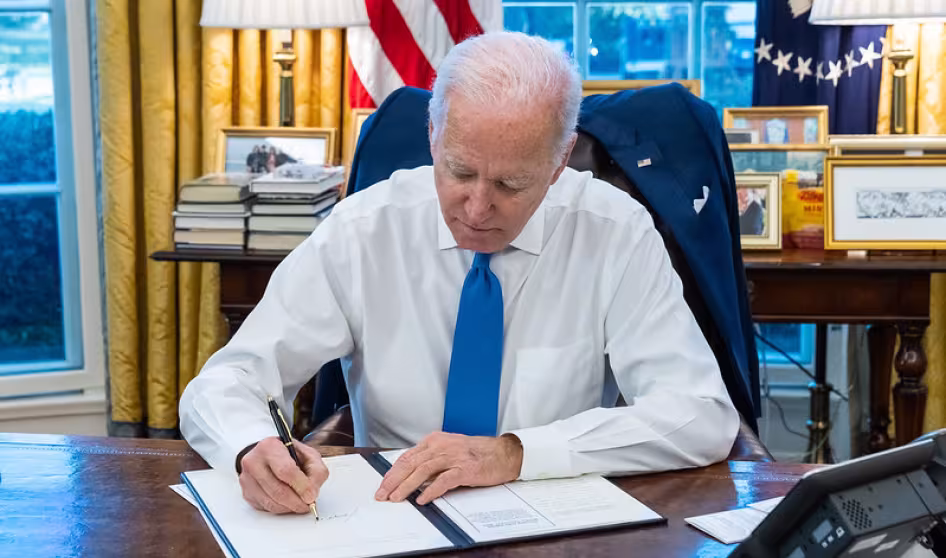 President Joe Biden signs an executive order.