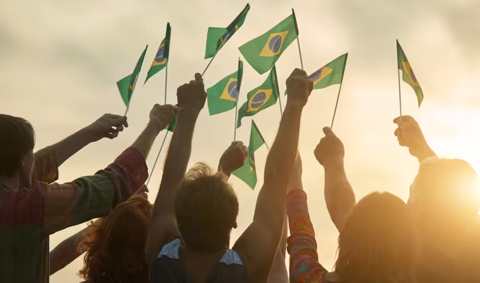 People hold Brazilian flags