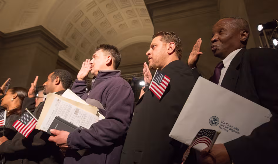 New U.S. citizens take an oath during a naturalization ceremony.