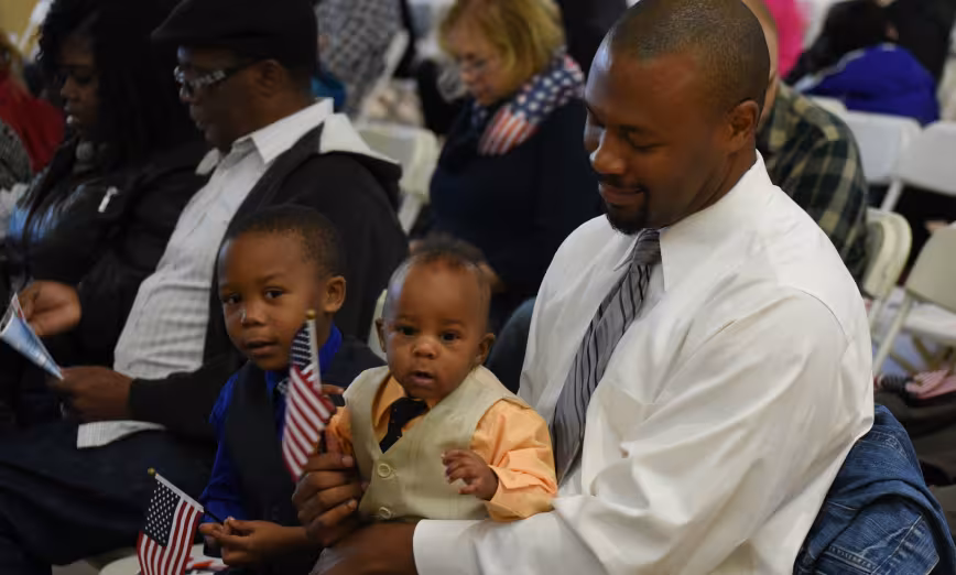 A man and child at a naturalization ceremony outside Washington, DC.