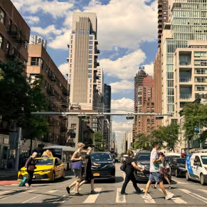 People at a pedestrian crosswalk crossing the street