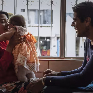 A family with a young child at an Orientation and Assistance Point in Bogota that offers services to Venezuelan refugees and migrants