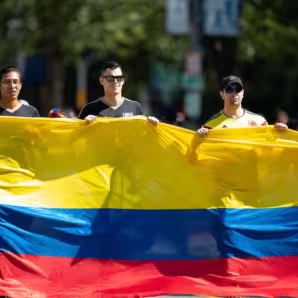 People carry a giant Colombian flag at a parade in Washington, DC