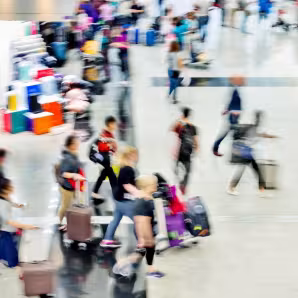 Blurred people walk across a terminal