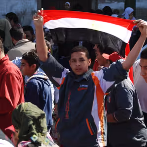 A young Egyptian protester holding an Egyptian flag, Cairo, Egypt