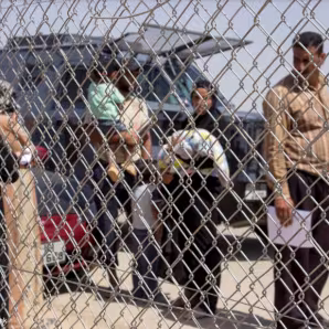 People behind a fence
