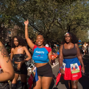 Young women smiling and dancing in the street