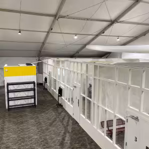 A series of empty white detention spaces