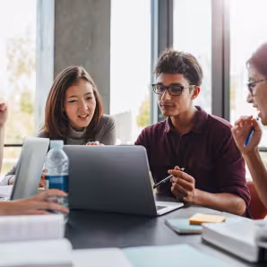 Group of students studying at a library