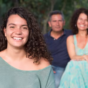 Image of parents posing with daughter