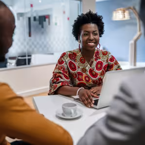 A Black female financial advisor in a meeting.