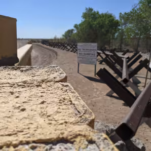 Fencing and a "no trespassing" sign at the U.S.-Mexico border