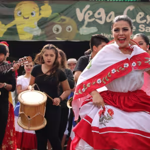 Migrants and natives dance at a multicultural celebration in La Vega, Chile.