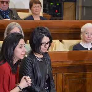 Twin sisters from Syria address a meeting. 
