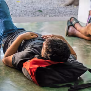 Central American migrant resting at Casa del Migrante in Tecun Uman, Guatemala