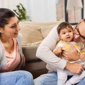 2 parents holding baby