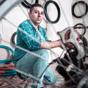 Iraqi man returned from Germany works in his repair shop