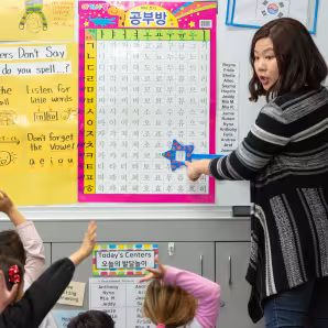 Teacher providing instruction in early childhood classroom