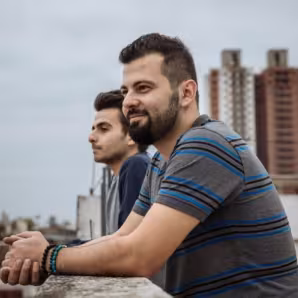 Syrian migrants look out over a city in Argentina