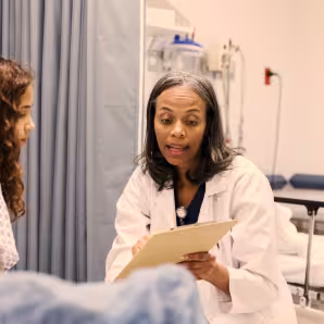 Doctor speaking with patient who is a child 
