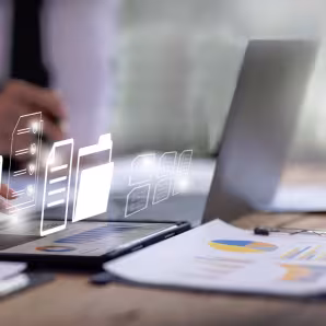 Computer on a table with other digital screens displayed in outline