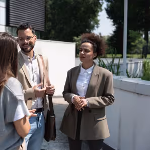 3 people in conversation on the street