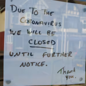 Paper with Closed until further notice in window due to the COVID 19 coronavirus pandemic