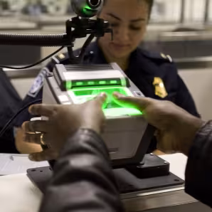 A traveler arriving at Washington Dulles International Airport Monday uses the new US-VISIT mechanism that records all 10 fingerprint images. (Gerald L. Nino/CPB)