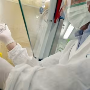 A doctor wearing a face mask performing a test