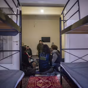 EU official with asylum-seeker family in Greece