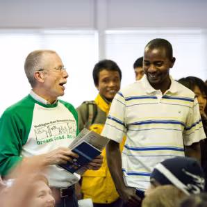A volunteer and refugees chat at a workshop in Spokane, Washington.