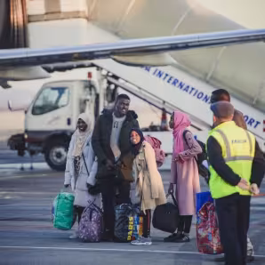 A family of refugees arriving at an airport during resettlement