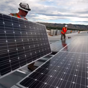 Workers install solar panels