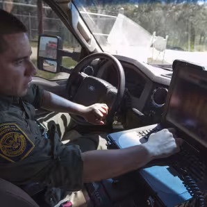South Texas Border Patrol agent inspects a truck at a CBP checkpoint.