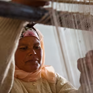 A woman in training center for production of local handicrafts.