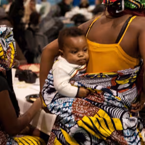 Mother and child at a local refugee art auction & fashion show.