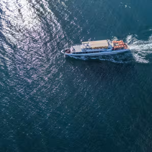 An aerial photo of a small boat at sea
